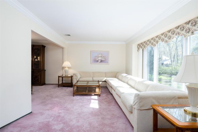 Living area featuring light colored carpet, visible vents, and crown molding | Image 9