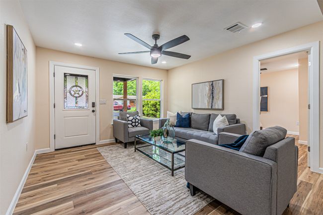Living area with ceiling fan, light wood-style flooring, baseboards, visible vents, and recessed lighting | Image 5
