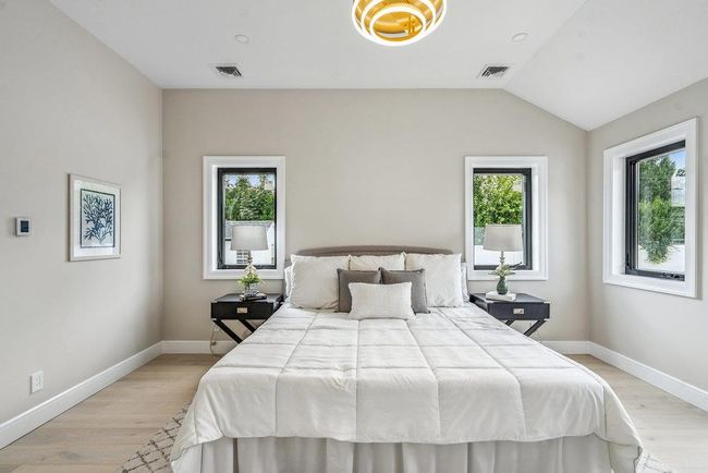 Sunlit Bedroom with vaulted ceiling and light Hardwood flooring, Recess Lighting, Walk-in Closets | Image 23