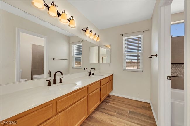 Bathroom with a wealth of natural light, a sink, and wood finished floors | Image 27
