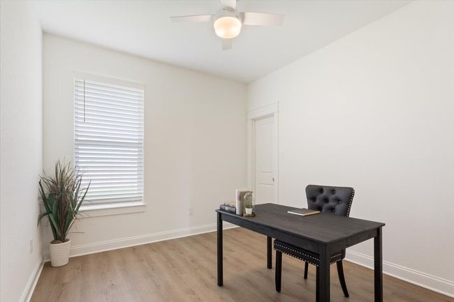 Office space featuring light wood-style flooring and ceiling fan | Image 27