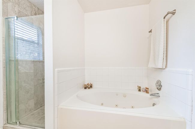 The large jetted tub and separate shower gives you options and room for relaxation. | Image 13