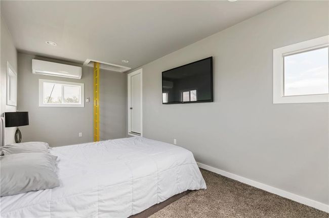 Bedroom with carpet flooring and a wall mounted air conditioner | Image 20