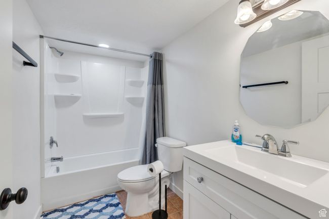 Full bathroom with vanity, tile patterned flooring, and shower / tub combo with curtain | Image 20
