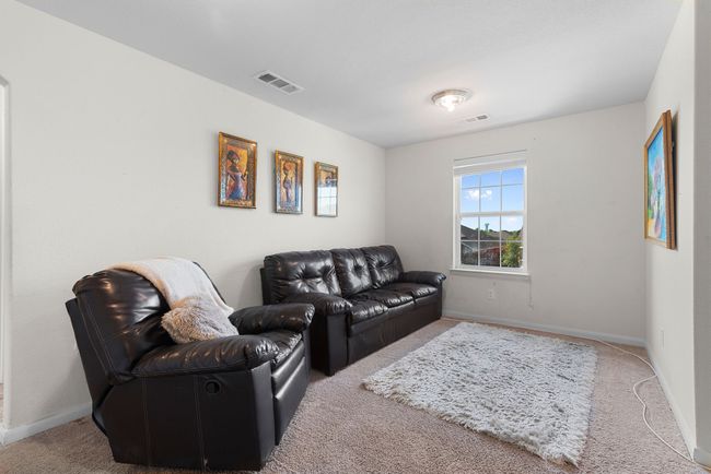 Carpeted living room featuring baseboards and visible vents | Image 19