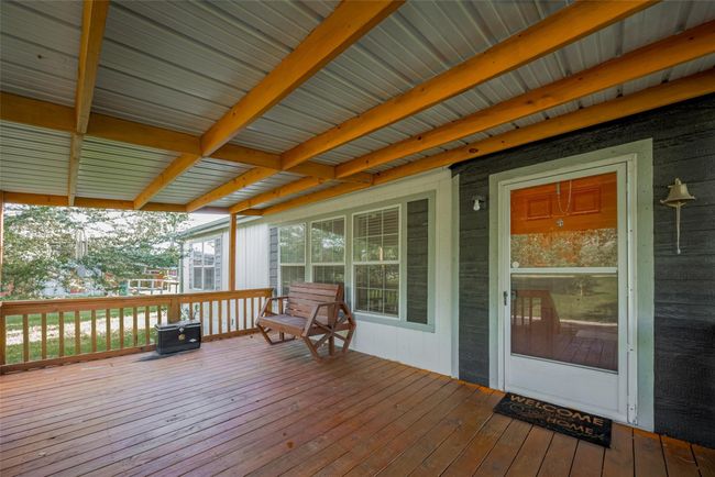 With a charming porch that invites you to relax on a cozy bench, perfect for enjoying the outdoors. | Image 7
