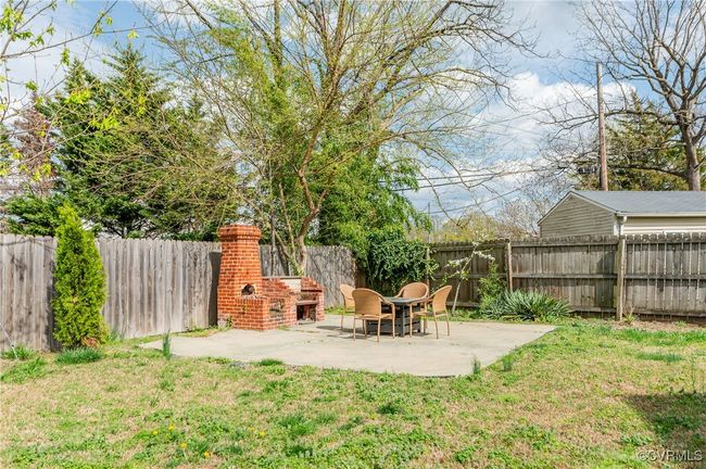 View of yard with a fenced backyard and a patio area | Image 49