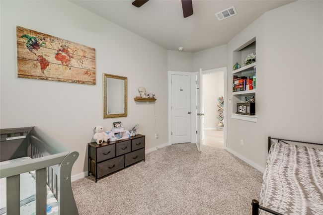Carpeted bedroom with a crib, baseboards, and ceiling fan | Image 30