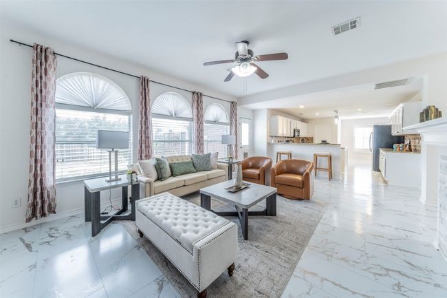 Living area with light marble finish floors, a ceiling fan, and recessed lighting | Image 6