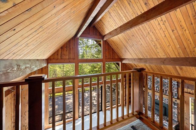 Small mezzanine floor offers elevated wooded views thru clerestory windows | Image 40
