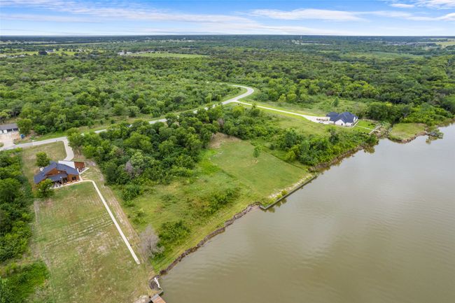 Aerial view of a forest and a nearby body of​​‌​​​​‌​​‌‌​‌‌​​​‌‌​​‌‌​‌​​​​​‌ water | Image 10