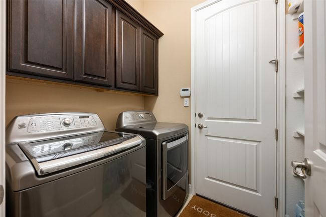 Washroom with separate washer and dryer and cabinet space | Image 29