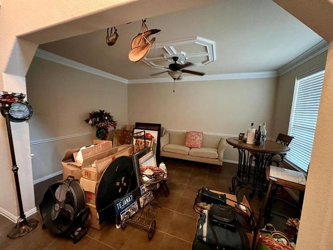 Living area featuring ceiling fan, tile patterned floors, and ornamental molding | Image 5