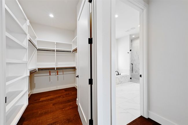 Spacious closet featuring dark wood-type flooring | Image 22