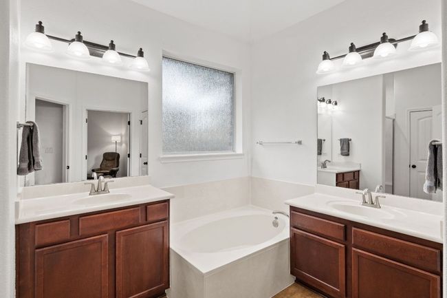 Full bathroom with two vanities and a garden tub | Image 29