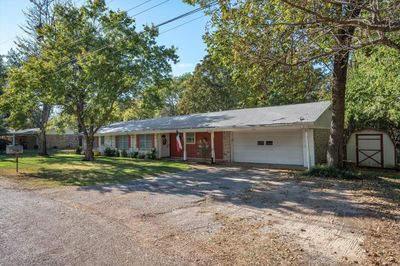 Ranch-style house with a front lawn and a garage | Image 3