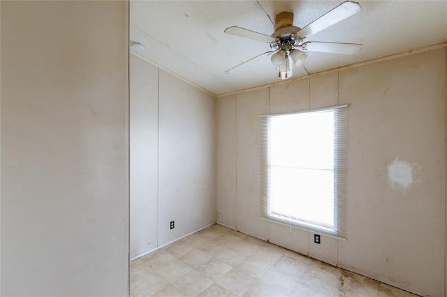 Empty room featuring ceiling fan | Image 4