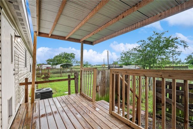 Wooden terrace with a fenced backyard | Image 22