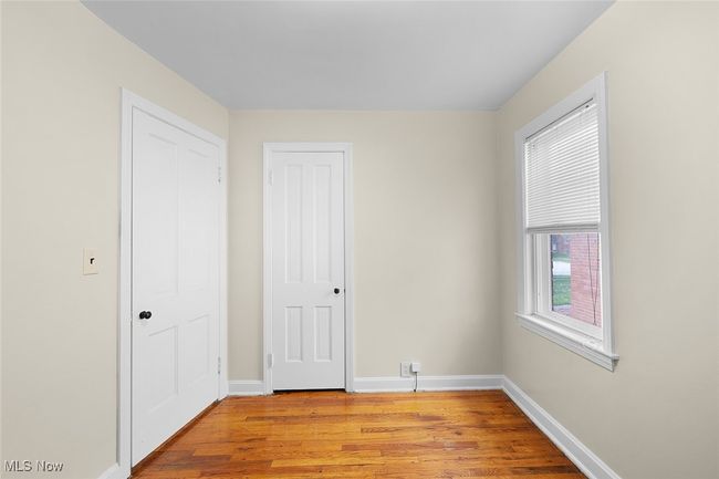 Unfurnished bedroom featuring light wood-style flooring and baseboards | Image 14