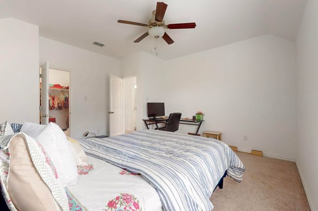 Bedroom featuring visible vents, a walk in closet, carpet floors, and a ceiling fan | Image 30