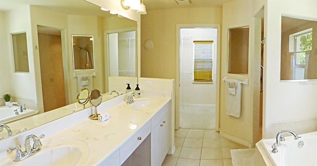 wow...the master bath features, double vanity with wide counter top, jet tub, walk-in shower with bench, and full dressing room | Image 38