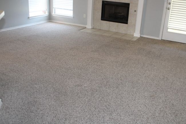 Unfurnished living room featuring carpet, a tile fireplace, and baseboards | Image 14