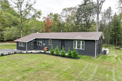 Single story home featuring a front lawn and central AC | Image 2