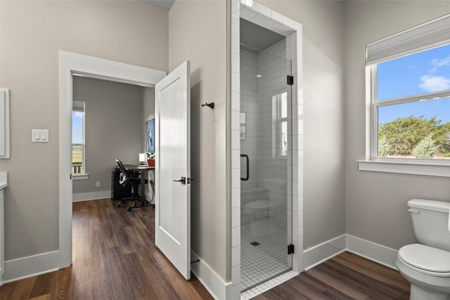 Bathroom featuring toilet, a shower stall, wood finished floors, and baseboards | Image 22