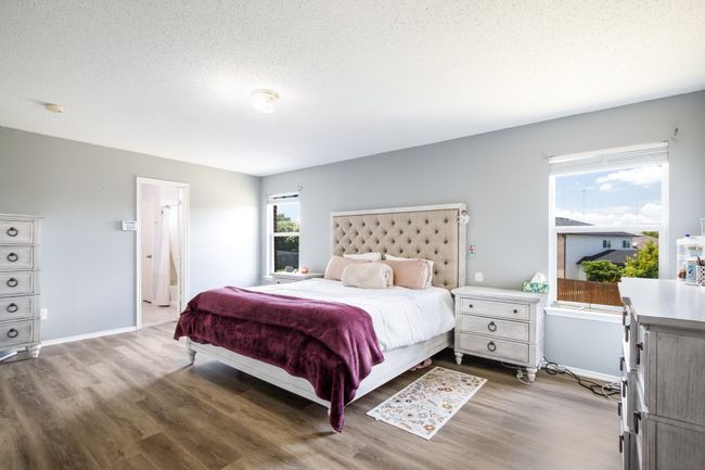 Bedroom with wood finished floors and a textured ceiling | Image 11