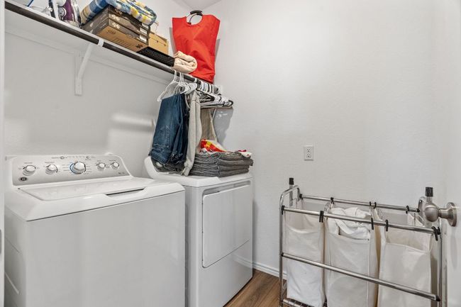 Clothes washing area featuring laundry area, separate washer and dryer, and wood finished floors | Image 28