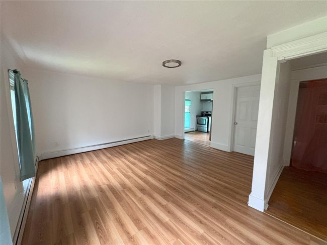 Unfurnished room with light wood-style floors, baseboards, a baseboard heating unit, and a baseboard radiator | Image 5