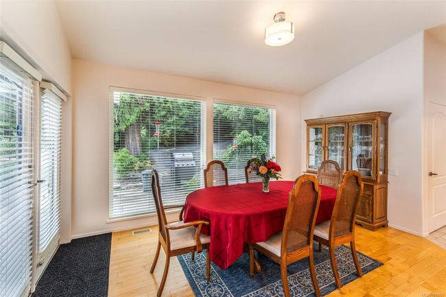 Dining area with plenty of natural light, light wood-type flooring, lofted ceiling, and baseboards | Image 13