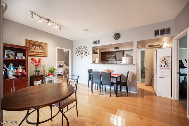 Dining space featuring light wood-style floors, visible vents, and baseboards | Image 8
