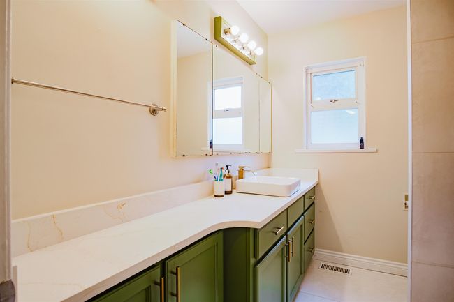 Bathroom featuring tile patterned floors, baseboards, visible vents, and vanity | Image 13