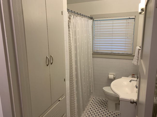 Side view of Bathroom showing storage and shower. | Image 14