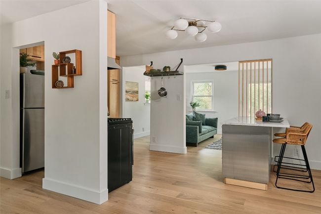 Centrally located kitchen with breakfast nook and custom wood details. | Image 4