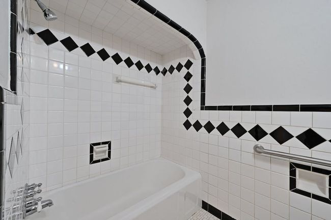 Bathroom with shower / bathing tub combination and tile walls | Image 14