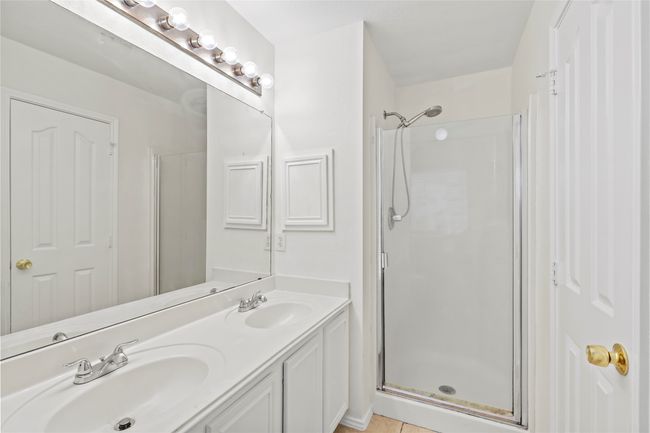 Bathroom with a sink, a stall shower, and double vanity | Image 15