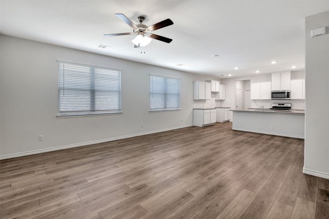 Unfurnished living room featuring ceiling fan, recessed lighting, and wood finished floors | Image 9