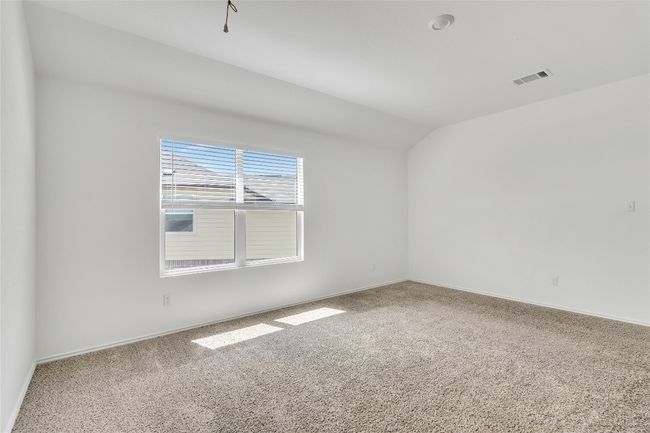 Empty room featuring carpet flooring and lofted ceiling | Image 23