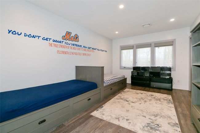Bedroom featuring dark wood-type flooring, visible vents, and recessed lighting | Image 21