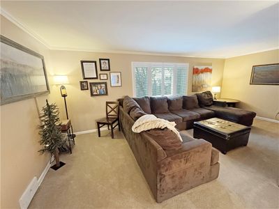 Large living room accented with crown moldings. | Image 3