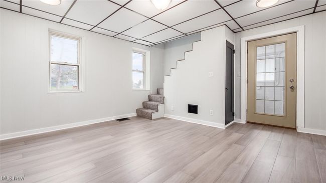 Dining room with stairway, light wood-style flooring, and a drop​​‌​​​​‌​​‌‌​‌‌​​​‌‌​​‌‌​‌​​​​​‌ ceiling | Image 8