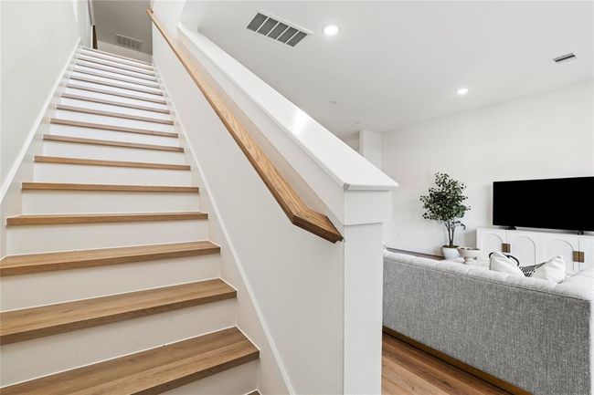 This staircase connects the main living space to the upper level, enhancing the home’s open-concept design. | Image 13