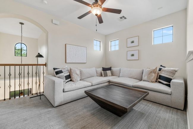 Upper Living area with ceiling fan, healthy amount of natural light, and arched walkways | Image 20