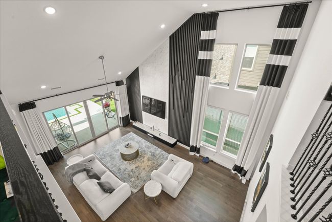 Living area featuring plenty of natural light, wood finished floors, recessed lighting, and high vaulted ceiling | Image 18
