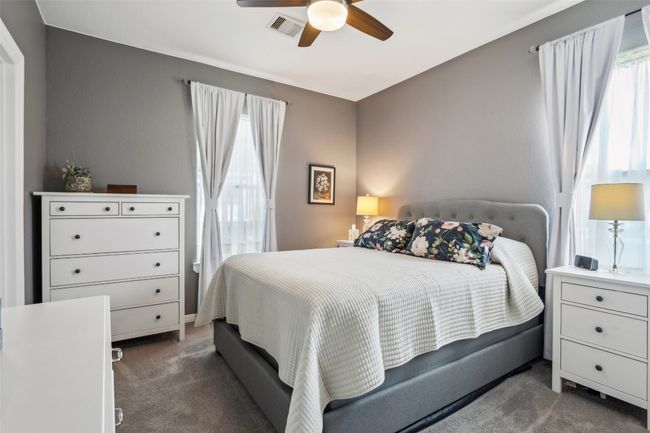 Primary Bedroom featuring visible vents, ceiling fan, multiple windows, and carpet | Image 22