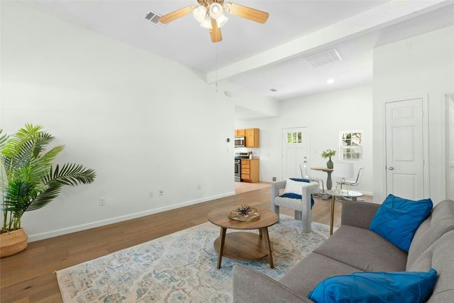 Living room with high ceilings, nice natural light and engineered hardwood floors | Image 5