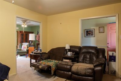 Living room featuring light colored carpet and ceiling fan | Image 3