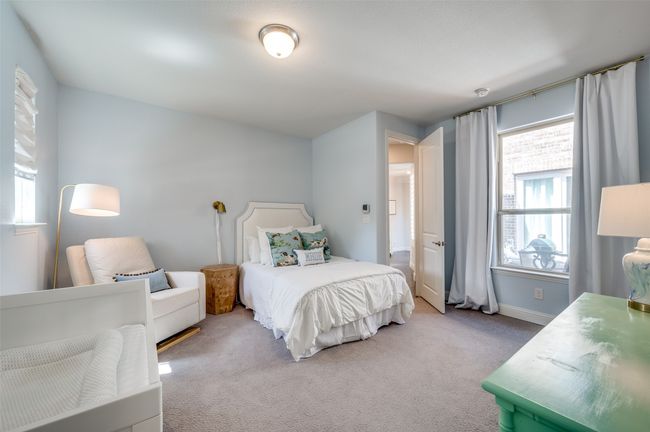 Secondary first floor bedroom is spacious and overlooks the court yard with en suite bath and walk in closet. | Image 23